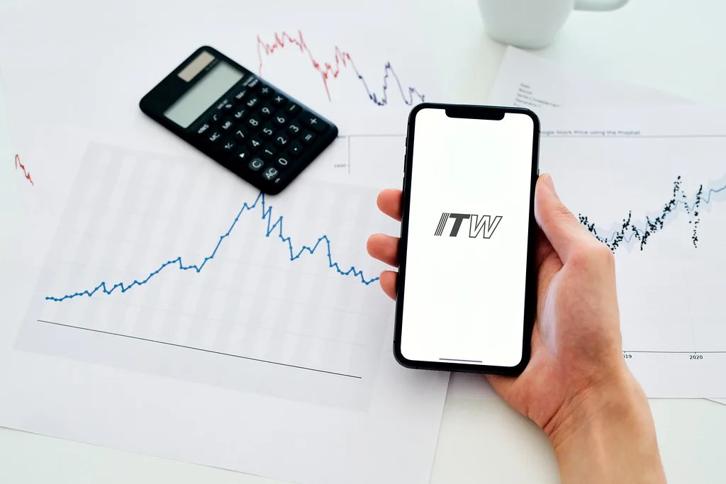 Analyst reviewing Illinois Tool Works stock buyback impact on trading screens