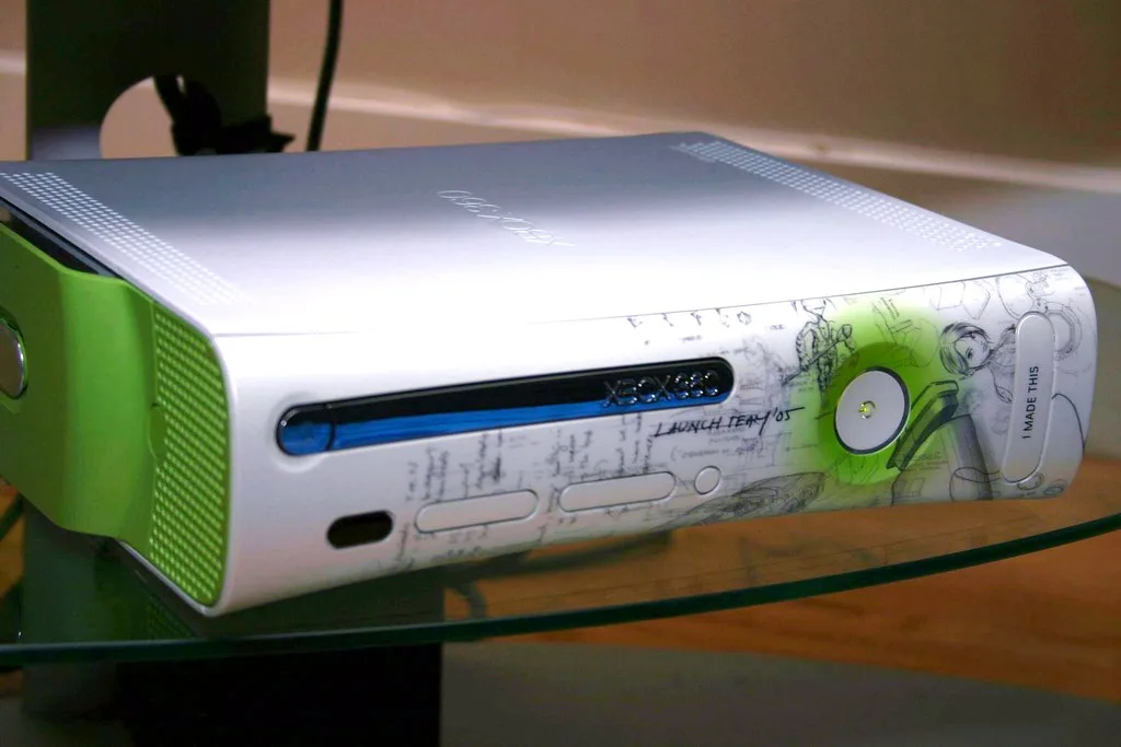 Handheld running Xbox 360 games on PC next to a laptop and controller